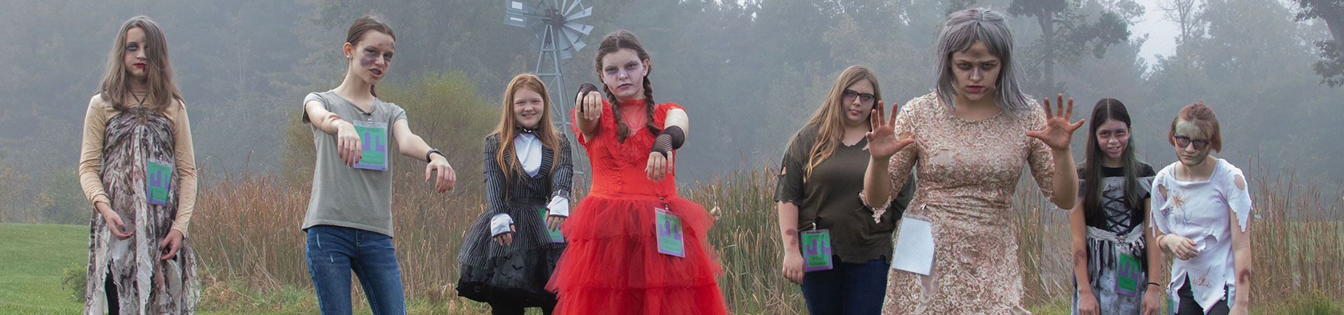  Six pre-teen girls dressed as zombies stand in a foggy field 