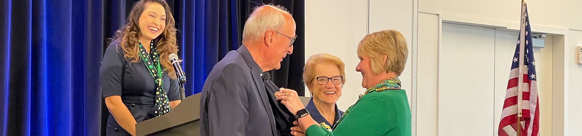  two adult girl scout lifetime members smiling and talking outside 